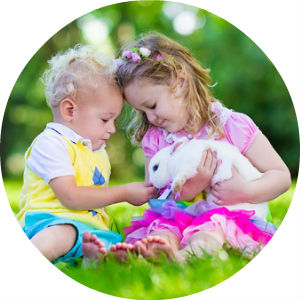 two children holding a bunny in a circle image