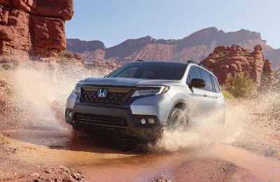 2019 Honda Passport exterior front fascia and drivers side splashing in canyon puddle