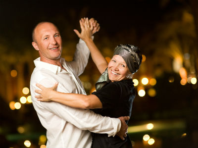 Middle-aged couple dancing indoors