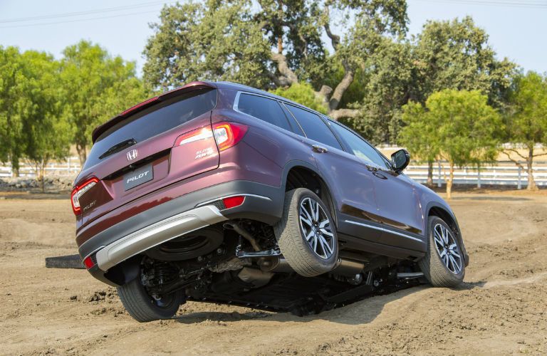 A photo of the 2020 Honda Pilot crossing an off-road course.