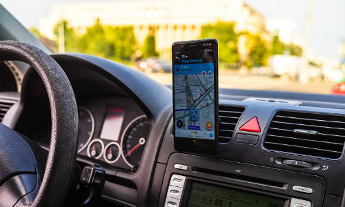 Smartphone mounted in vehicle with map on screen