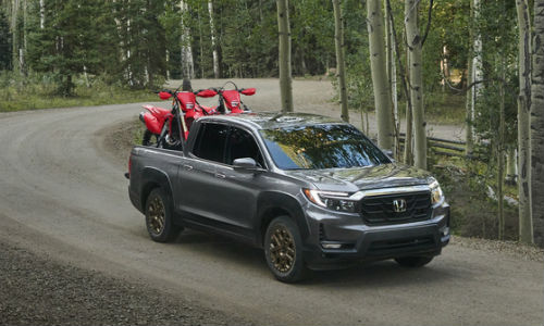 Gray 2021 Honda Ridgeline with dirt bikes in truck bed