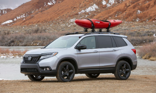 Silver 2021 Honda Passport with canoe on roof