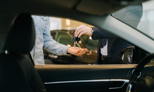 Individuals exchanging car keys