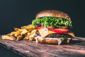 Cheese burger with fries with black background